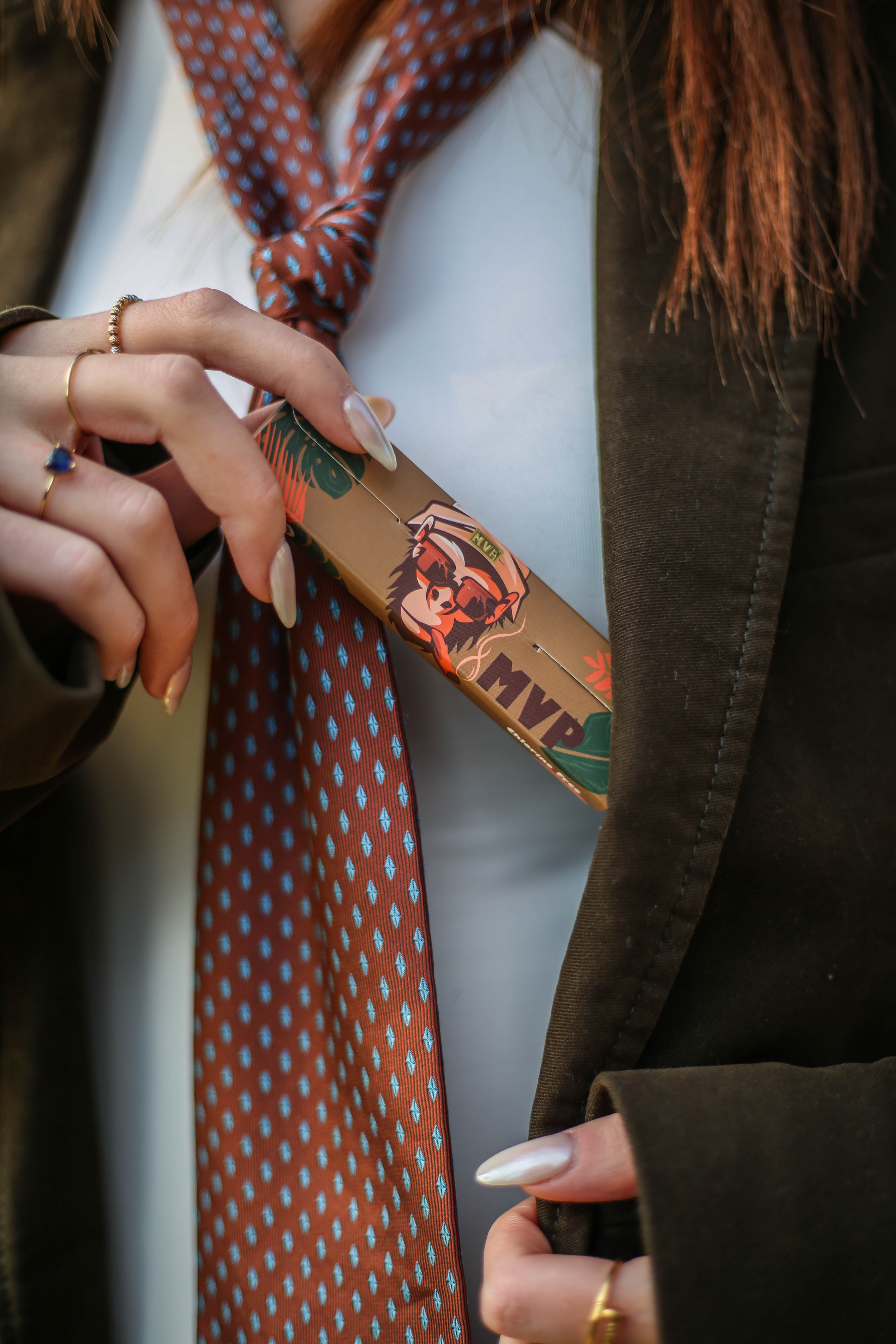 MVP booklet held beside a suit jacket and patterned tie